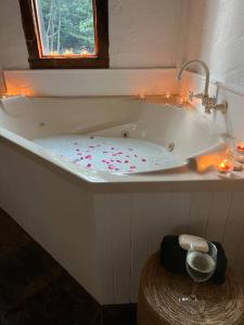 a bath tub with candles and lights in a bathroom at DAYLESFORD Frog Hollow Estate THE BARN - Wanting a different experience - Stay in the Barn - Table Tennis Table - Cinema Projector - Bar - Wood Fireplace - 3 QUEEN BEDS - A fun place for everyone in Daylesford