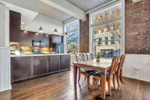 a kitchen and dining room with a wooden table and chairs at Elm St Retro Retreat- Downtown Close to Local Amenities in Greensboro