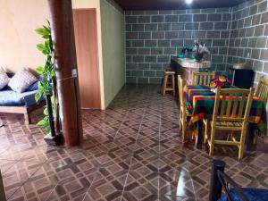 a living room with a table and chairs and a floor at Villa EL PIÑON en Ezequiel Montes in Ezequiel Montes