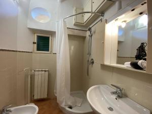 a bathroom with a sink and a toilet and a mirror at Accademia Apartment in Florence