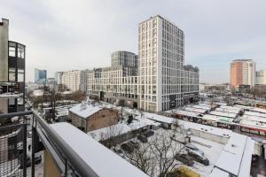 a view of a city in the snow at Czapelska Apartment Warsaw Praga Południe in Warsaw