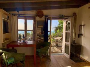 une chambre avec une table, des chaises et une fenêtre dans l'établissement Tiny House Vogelnest, à Puntagorda
