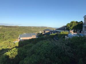 a house on top of a hill with trees at Pezula Holiday in Knysna