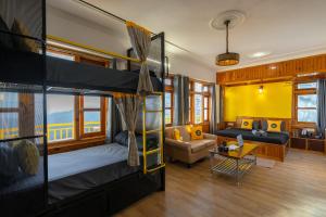 a room with two bunk beds and a couch at The Hosteller Narkanda in Nārkanda