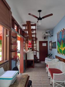a room with a table and chairs and a staircase at Pousada do Rei in Ubatuba +24 photos