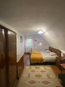 a small room with two beds and a window at Domek z duszą in Szklarska Poręba