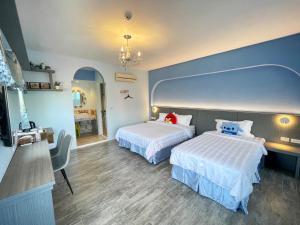 Ένα ή περισσότερα κρεβάτια σε δωμάτιο στο Wonderful Kenting Hostel
