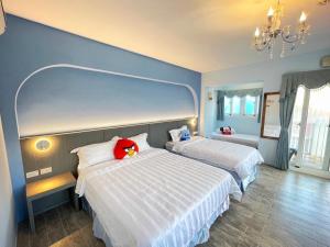 Ένα ή περισσότερα κρεβάτια σε δωμάτιο στο Wonderful Kenting Hostel