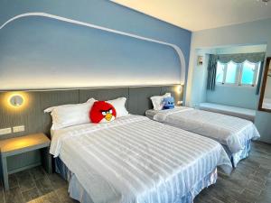 Ένα ή περισσότερα κρεβάτια σε δωμάτιο στο Wonderful Kenting Hostel