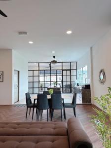 a living room with a table and chairs at PRIVATE POOL SEALIVE Home 1 in Kuala Terengganu