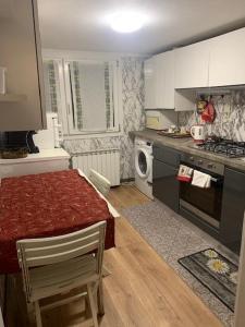 a small kitchen with a table and a microwave at Hotel La Pergola di Venezia in Venice-Lido