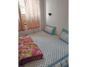 een slaapkamer met een bed en een raam bij Lucknow Home Stay, Lucknow in Lucknow