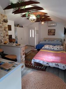 a bedroom with two beds and a kitchen in it at Studio Apartments KIM - Dilberovic in Mostar