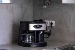 a coffee maker sitting on top of a kitchen counter at Villa Arkadia in Parasporos