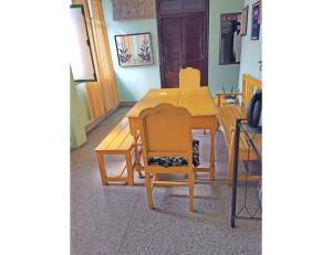 a wooden table and chairs in a room at Lucknow Home Stay, Lucknow in Lucknow