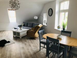 a living room with a couch and a table at Holzmichl in Varel