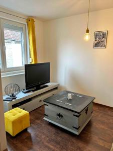 a living room with a flat screen tv on a table at Not far from Wissant in Marquise +18 photos