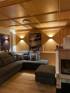 a living room with a couch and a fireplace at Haus Almweg in Kirchberg in Tirol