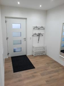 a room with a white door and a wooden floor at Kelbergerly Hills in Kelberg