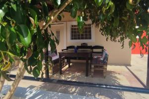 a table and a chair in front of a house at Olive Grove Cottage Skalani in Knossós +81 photos