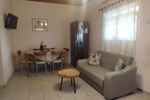 a living room with a couch and a table at Olive Grove Cottage Skalani in Knossós