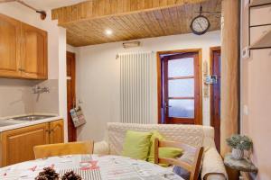 a kitchen with a table and a clock on the wall at Lanzada 2 in Lanzada