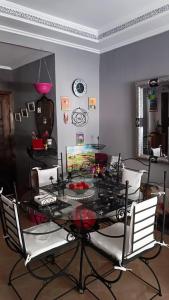 a dining room with a black table and chairs at Chez Axia Tanger in Tangier