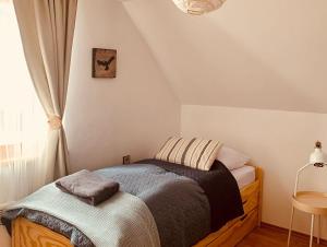 A bed or beds in a room at Chalupa Nad Lipou - Čičmany, turistika, sauna, krb