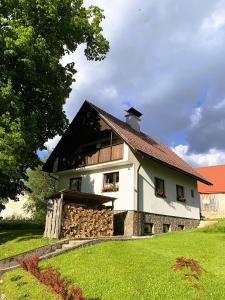 duży biały dom z czarnym dachem w obiekcie Chalupa Nad Lipou - Čičmany, turistika, sauna, krb w mieście Čičmany