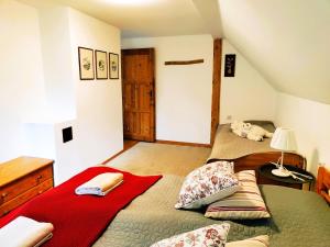 A bed or beds in a room at Chalupa Nad Lipou - Čičmany, turistika, sauna, krb
