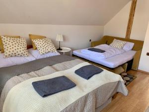 A bed or beds in a room at Chalupa Nad Lipou - Čičmany, turistika, sauna, krb