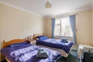 a bedroom with two beds and a window at Bungalow in Spey Bay, Moray (Disabled Accessible) in Kingston