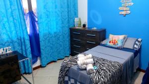 um quarto azul com uma cama e uma cómoda em Recreio - CorAll Residence - 2 Quartos e 1 Suíte no Rio de Janeiro