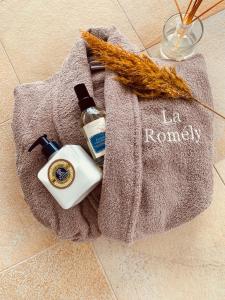 a gray towel on the floor with a bottle of alcohol at La Romély in Arzier