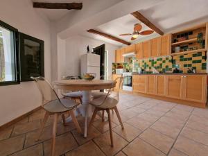 a kitchen with a table and chairs and a refrigerator at Casa Rincon a detached two bed cottage in Lubrín