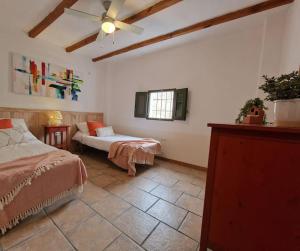 a large room with two beds and a window at Casa Rincon a detached two bed cottage in Lubrín