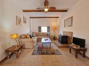 a living room with a couch and a tv at Casa Rincon a detached two bed cottage in Lubrín