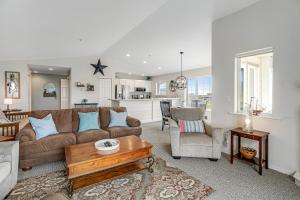 a living room with a couch and a table at Once Upon a Tide in Westport