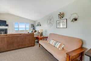 a living room with two couches and a table at Once Upon a Tide in Westport