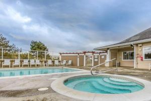 a swimming pool with chairs and a house at Once Upon a Tide in Westport