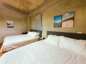 En eller flere senge i et værelse på 日安池上民宿Buongiorno Chishang B&B