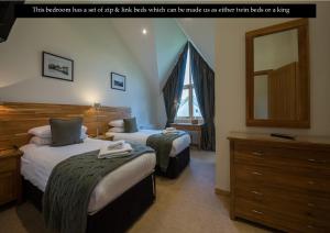 a bedroom with two beds and a mirror and a dresser at Mains of Taymouth Country Estate 5* Maxwell Villas in Kenmore