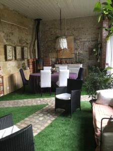 a patio with a table and chairs on green grass at Troglodytes "Loire Sauvage" in Rochecorbon +2 photos
