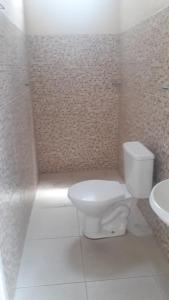 a bathroom with a toilet and a sink at Porto apartamento in Porto Seguro +8 photos
