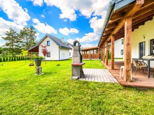 a house with a wooden porch and a patio at Wikno Port in Wikno