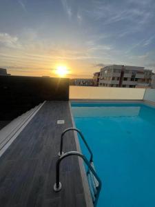 a swimming pool on the roof of a building at Kriol Guest House in Praia