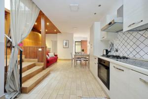 a kitchen and living room with a red couch at Vatican Spacious Apt with Terrace in Rome