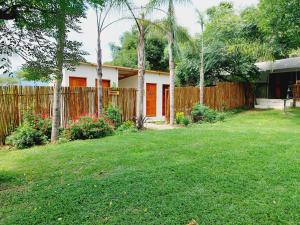 a house with a fence and a yard at Rockview Lodge in Nelspruit