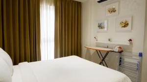 Postel nebo postele na pokoji v ubytování RELOhomes Serviced Apartment