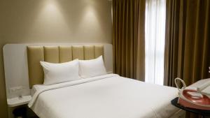 Postel nebo postele na pokoji v ubytování RELOhomes Serviced Apartment